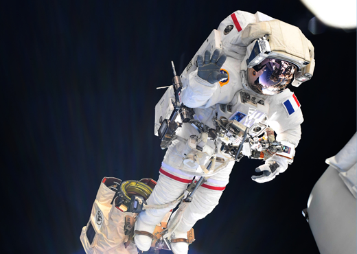 ESA astronaut Thomas Pesquet riding Canadarm2 during the first spacewalk of his Alpha mission on 16 June 2021.